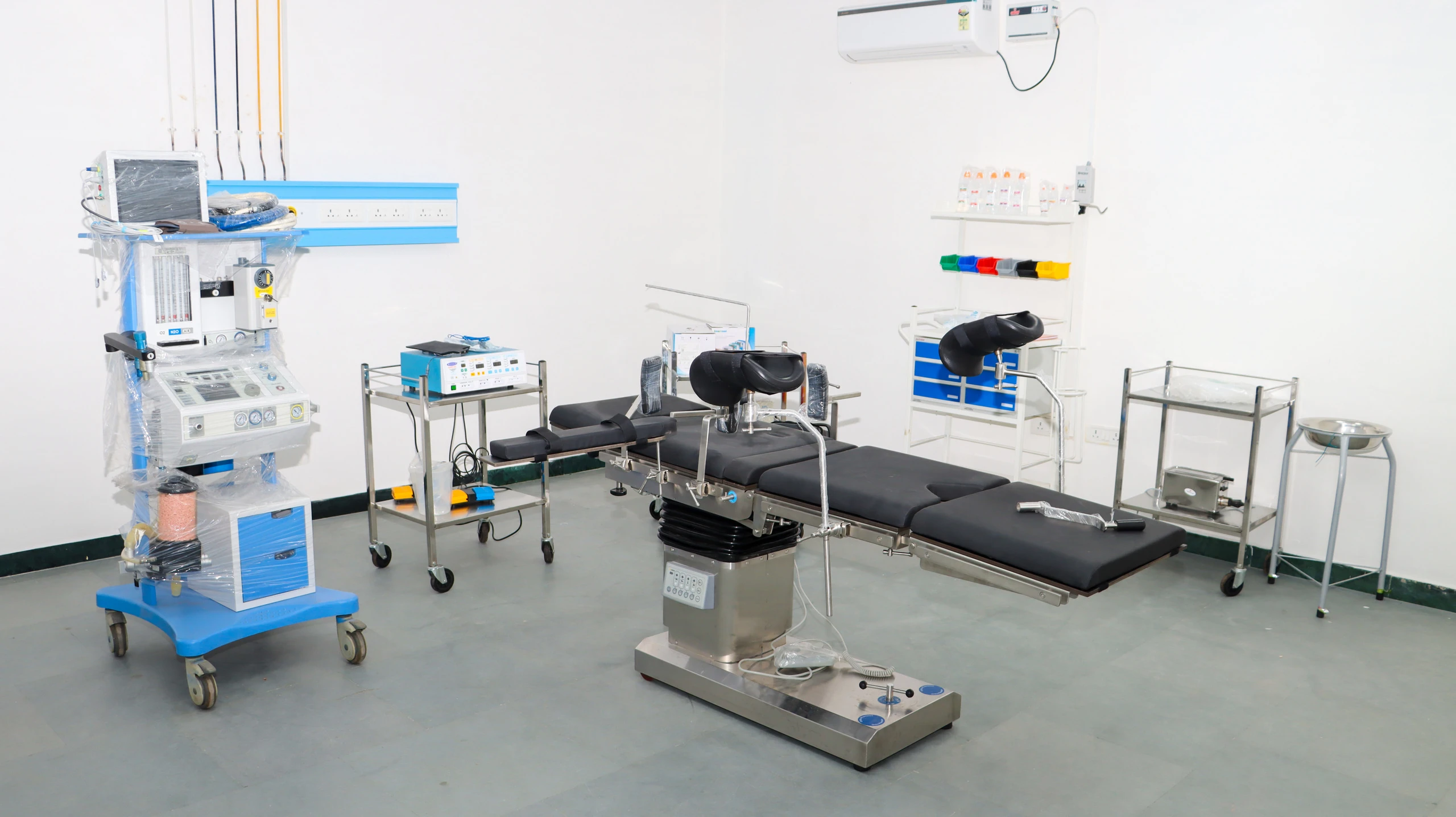 An operation theatre with an operating table and an anaesthesia machine