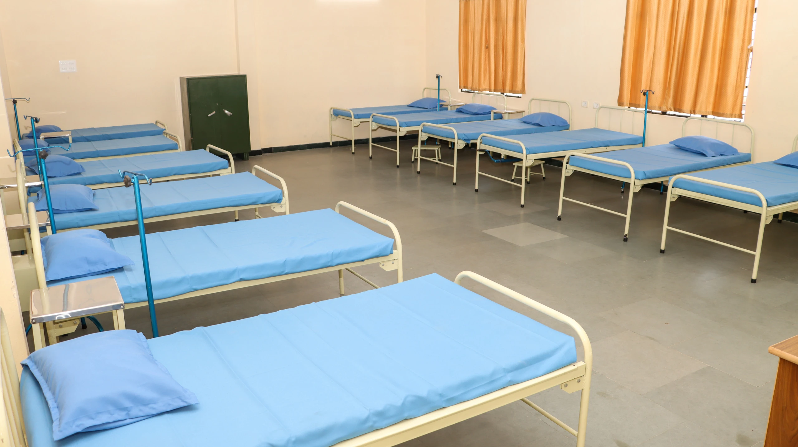 A large ward with rows of hospital beds